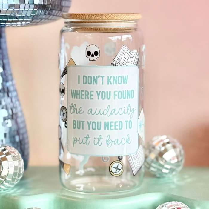 Glass jar with text on a stand with disco balls and a pink background