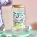 Glass jar with a motivational quote on a colorful background with disco balls and a disco mushroom.