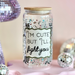 Decorative jar with a humorous message surrounded by disco balls and a mirror ball on a pink platform.