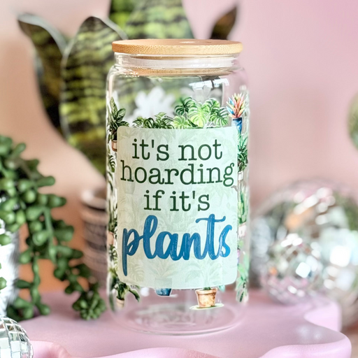 Decorative jar with 'it's not hoarding if it's plants' text, surrounded by small plants and disco balls on a pink background.