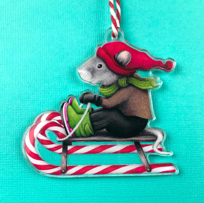 Abundance Illustration - Holiday ornament sledding mouse with striped string